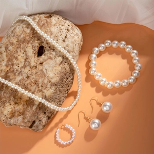 Elegant four-piece imitation pearl jewelry set with necklace bracelet and earrings