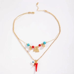 Hawaiian double layer necklace with elephant, chili and evil eye charms on white background