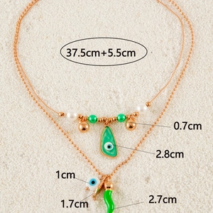 Detail of layered beach necklace with pepper and evil eye charms showing 37.5cm length
