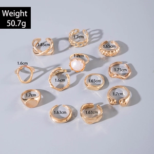 Detailed view of 11-piece vintage gold ring set with diverse textures and size markers