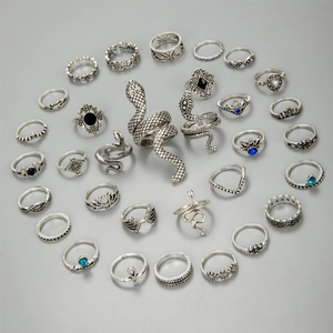 Retro silver ring set with snake, lotus, and bohemian gemstone designs in a circular layout