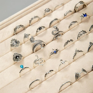Retro silver 32-piece ring set with snake and lotus designs in a jewelry box