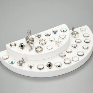 Retro silver snake ring set with blue gems and boho lotus crown designs displayed on white stands