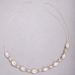 Detail of beach waist chain with starfish, shells, and white beads on a soft cord
