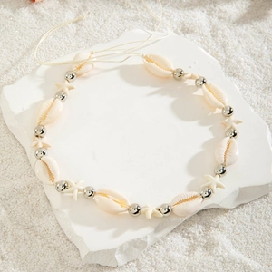 Detail of beach waist chain with sea shells, silver beads and white star charms