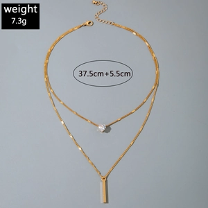 Detailed view of 7.3g gold layered necklace with heart zircon and metal bar pendant