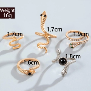 Detailed set of snake rings featuring gold and silver plating with green gem accents