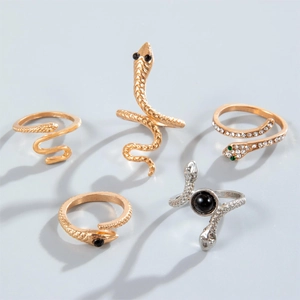 Detail of 5pcs snake ring set with scales, green crystals and black bead accents