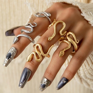 Detailed close-up of gold and silver snake rings featuring realistic scale textures