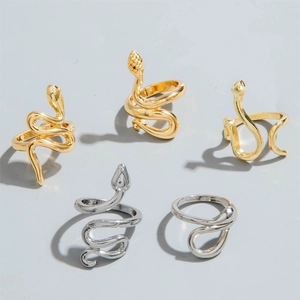 Detail view of 5-piece snake ring set in gold and silver finish with bohemian aesthetic