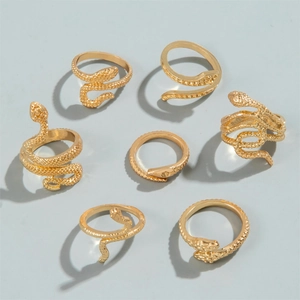 Detailed close-up of a 7-piece set of golden snake rings with realistic scale texture