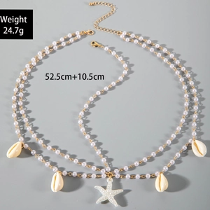 Détail de la chaîne de tête multicouche avec perles, étoile de mer et coquillages blancs