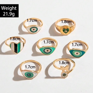 Lot de 7 bagues dorées avec motifs œil maléfique, papillon, cœur et détails en émail