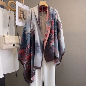Detail of grey cashmere-like shawl featuring traditional landscape painting and frayed edges