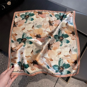 Detailed view of silk square scarf featuring vintage floral print and elegant satin luster