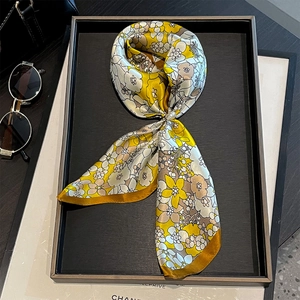 Detailed macro view of floral 53cm silk scarf with yellow border and pearl decoration
