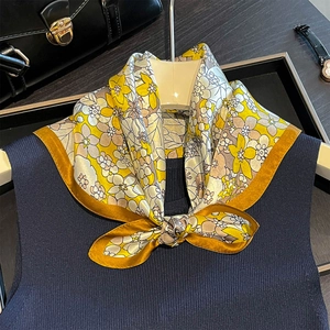 Elegant 53cm yellow floral silk square scarf tied on a navy knit vest for a stylish look