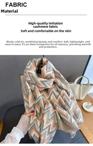 Detail of grey and orange herringbone imitation cashmere scarf with soft fringe trim