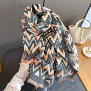 Thick geometric wavy stripe scarf with fringe trim in grey, orange, and beige knit