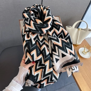Close-up of geometric wave pattern scarf with thick fringe and premium cashmere texture