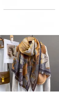 Detail view of the soft faux cashmere scarf featuring elegant floral art and fringe