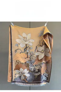 Close-up of jacquard scarf with Chinese lotus motifs and delicate fringe detail