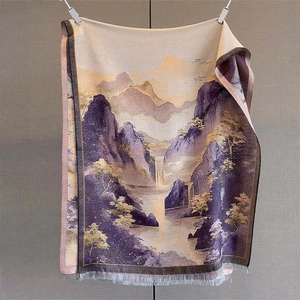 Detail of artistic mountain landscape scarf with elegant tassels and silk-like texture