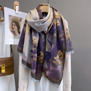 Detail of artistic landscape pattern scarf with soft tassels and rich texture