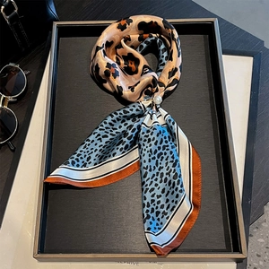 Classic leopard print silk scarf with mixed colors and pearl ring on display