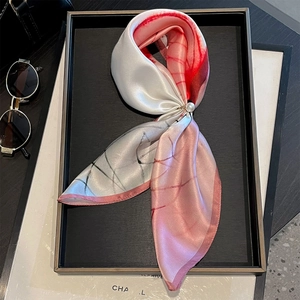 Detail of silk scarf with pink gradient, thin lines, and a gold pearl ring clasp buckle