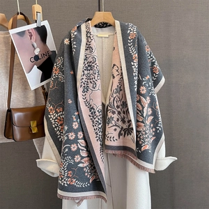 Floral jacquard pashmina scarf in grey and pink with fringe detail over a coat