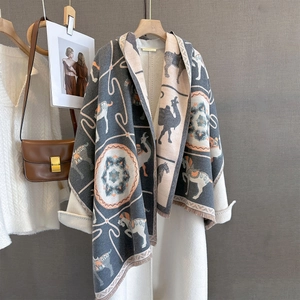 Detailed view of jacquard animal pattern scarf with fine fringe on high-quality fabric