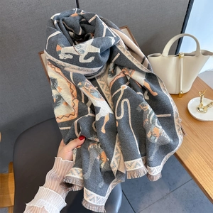 Detail of premium horse jacquard scarf featuring fine fringe and soft gray cashmere texture