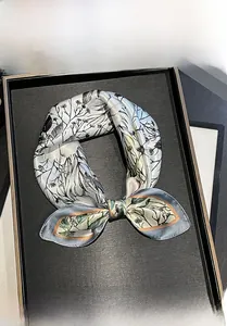 Detail showing 100% mulberry silk scarf with floral patterns used as a headband or belt