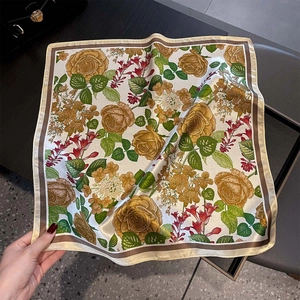 Detailed view of silk square scarf featuring vintage yellow rose patterns and fine edges