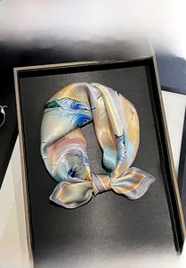 Detail of 100% mulberry silk scarf tied in a bow with abstract floral art prints