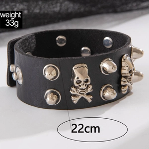 Close-up of punk leather wristband with silver skull studs and spikes, 22cm long