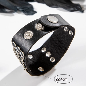 Detail of punk black leather cuff bracelet with silver studs, chain, and 22.4cm size mark