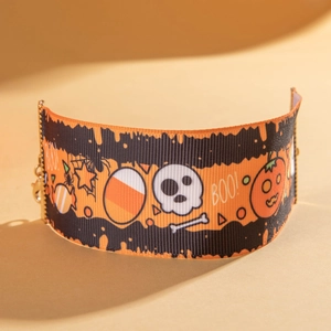 Detail of Halloween punk choker with orange wavy stripes, skull, and pumpkin patterns