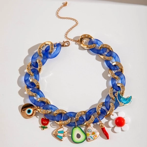 Close-up of chunky gold and blue acrylic chain necklace with colorful multi-element charms