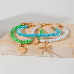 Three-piece bohemian braided anklet set with starfish, shell, and fish gold charms