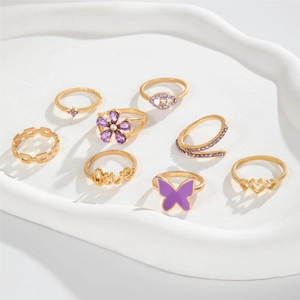 9-piece gold-tone fashion ring set with purple butterfly, Love motif, and zircon accents