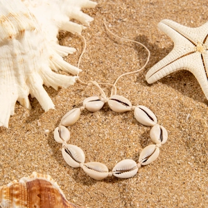 Bohemian shell anklet with natural cowrie shells on rope for beach vacation style