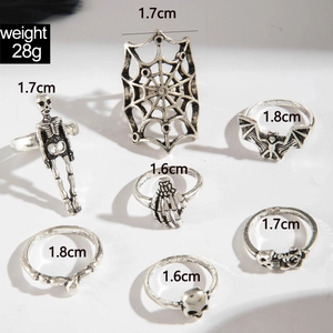 Detailed view of 7-piece gothic punk ring set with skull and spider motifs in vintage silver