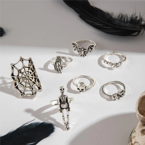 Macro view of 7-piece vintage silver gothic ring set featuring skulls and spiders