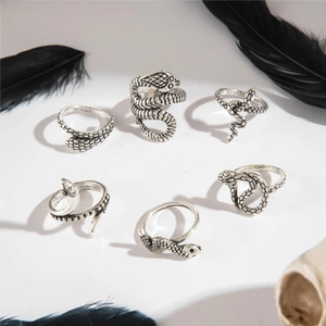Detail of 6-piece vintage silver snake ring set with gothic punk scale textures