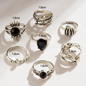7-piece gothic punk ring set with black rhinestones and skull hand details