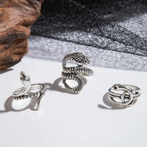 Close-up of gothic punk snake rings featuring detailed scales and vintage silver finish