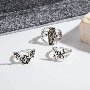 Detailed view of Gothic rings featuring bat, spider, and skull coffin designs in retro silver