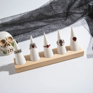Close-up of gothic skull rings with red stones and roses in a dark vintage set